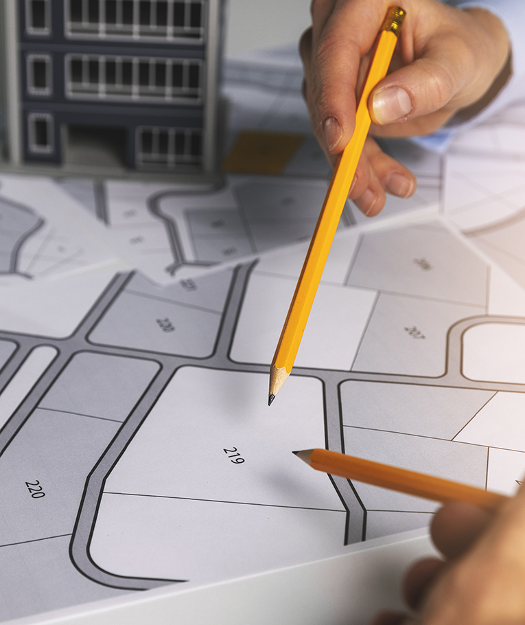 urban planning - people discussing about territory building plots on cadastral map for apartment building construction